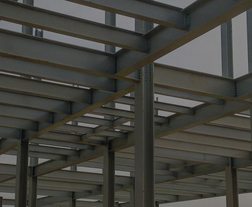 Background with dark overlay of erected structural steel on an industrial construction site.