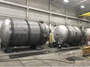 Two C-276 reactors with 2205 duplex half-pipe jacket in fabrication shop.