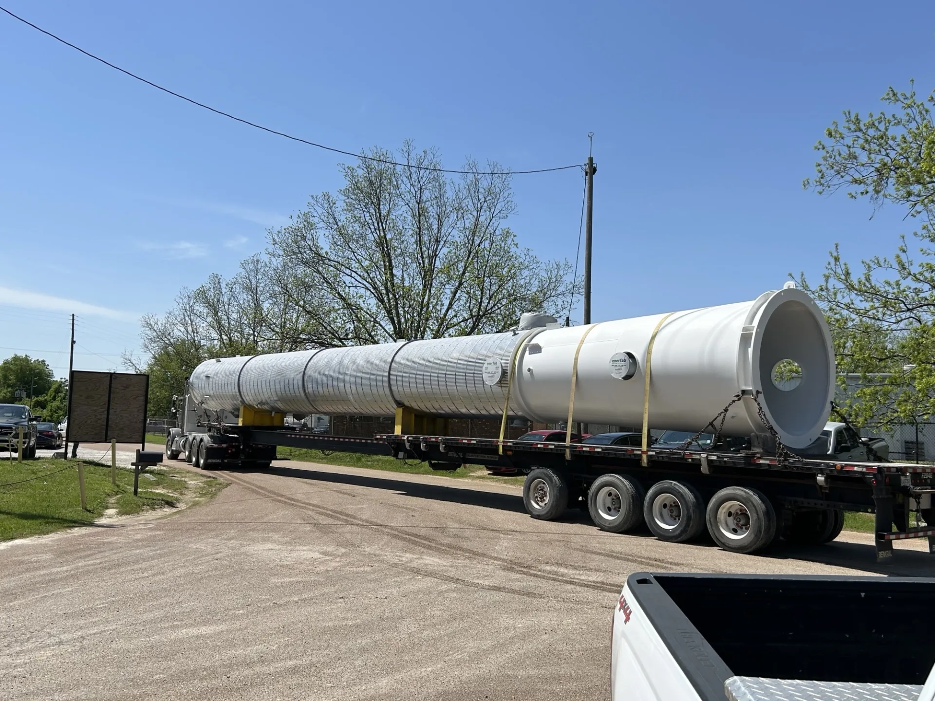 A process column loaded onto a truck trailer.