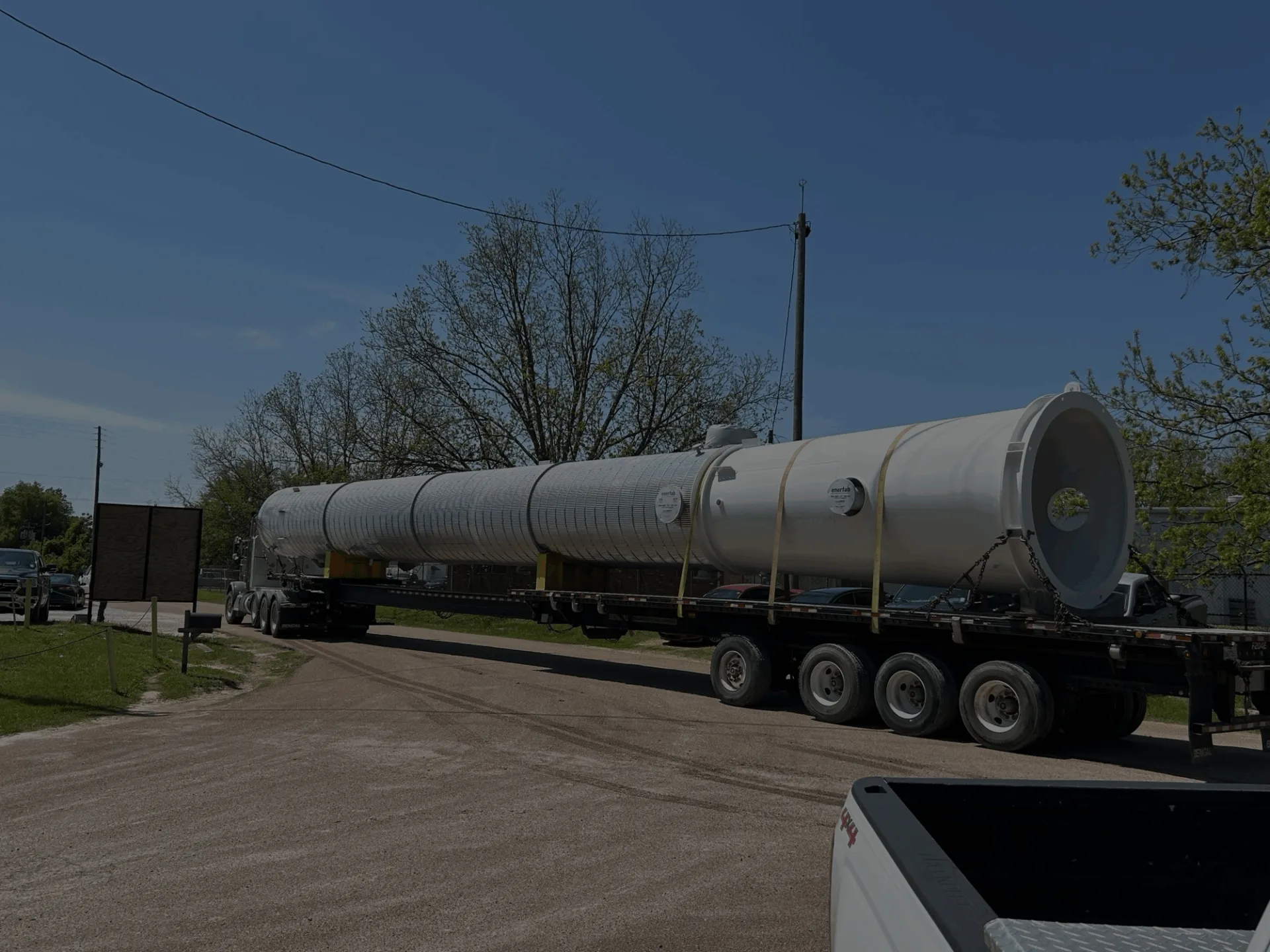 A process column loaded onto a truck trailer.